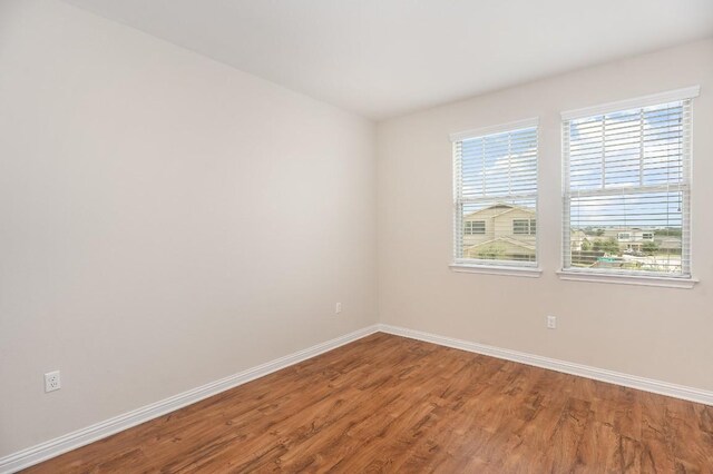 empty room with hardwood / wood-style flooring