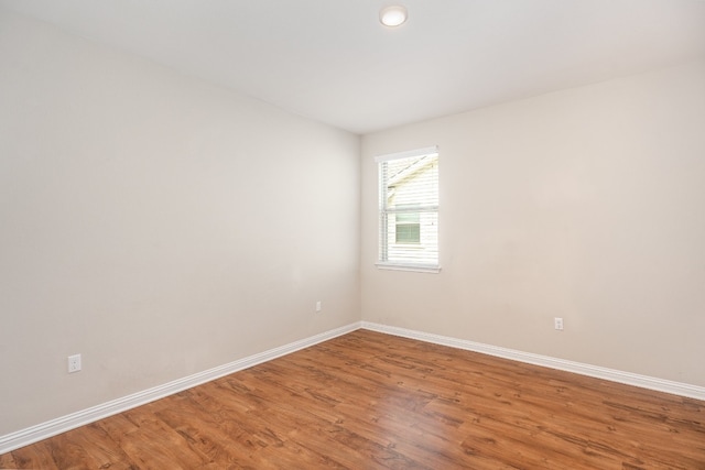 unfurnished room featuring hardwood / wood-style flooring