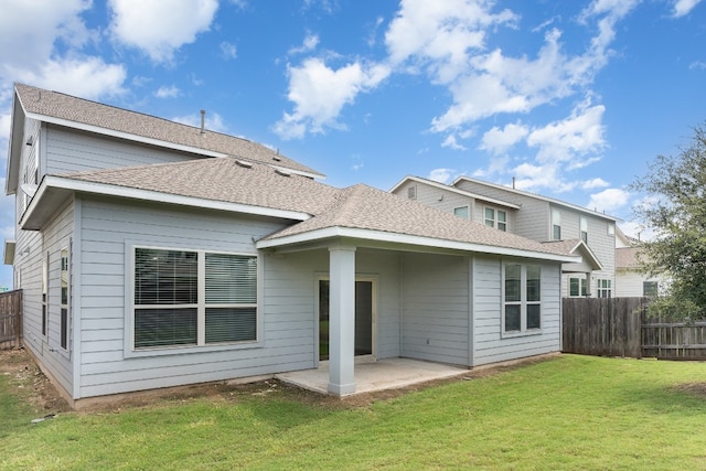 back of house with a lawn and a patio area