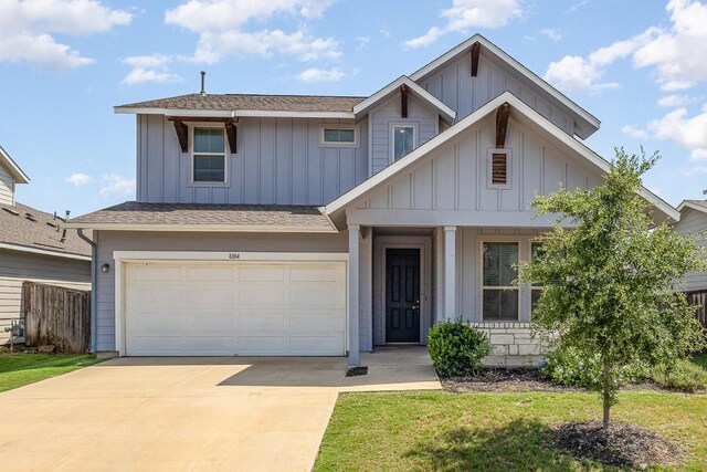 view of front of home featuring a garage and a front yard