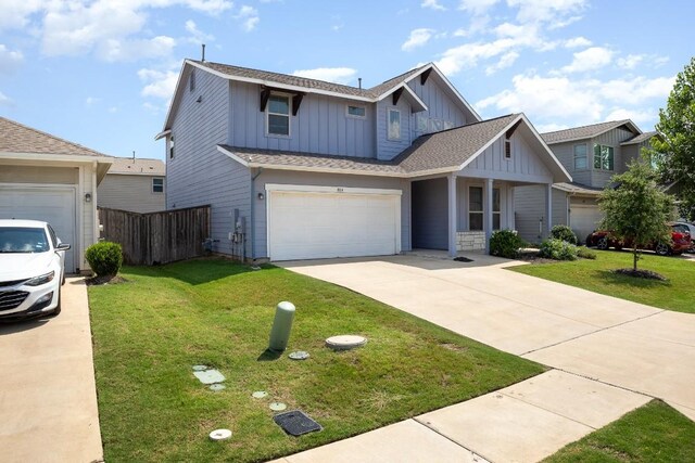 view of front of house with a garage and a front yard