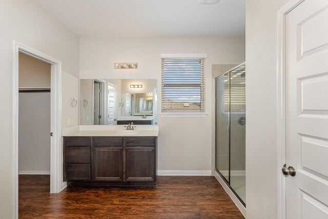 bathroom featuring vanity, hardwood / wood-style flooring, and walk in shower