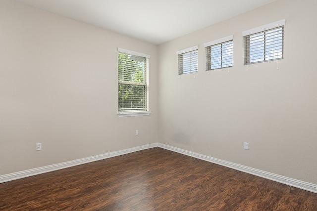 spare room featuring dark hardwood / wood-style floors