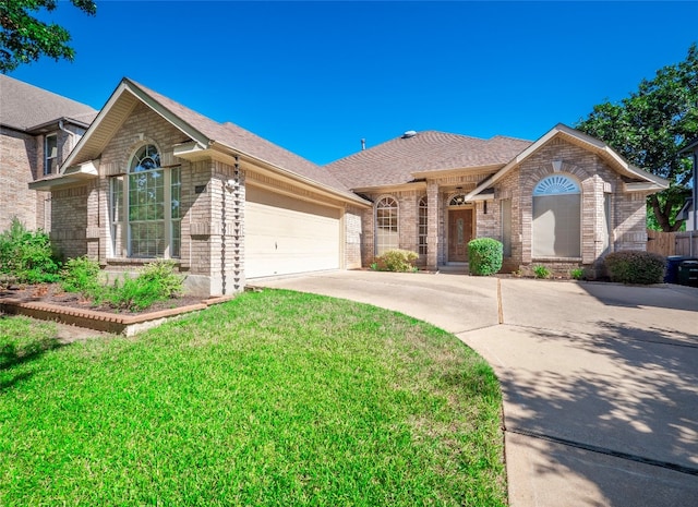 ranch-style home with a garage and a front lawn