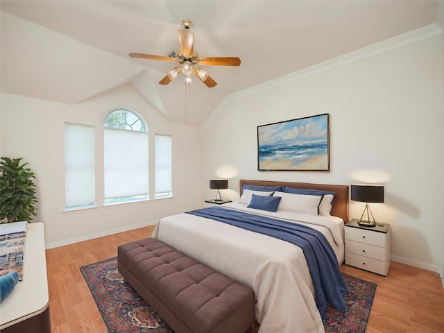 bedroom with ceiling fan, ornamental molding, light wood-type flooring, and vaulted ceiling