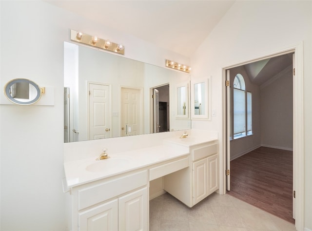 bathroom featuring lofted ceiling, hardwood / wood-style floors, and vanity