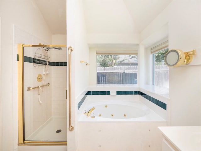 bathroom with plus walk in shower, vanity, and vaulted ceiling