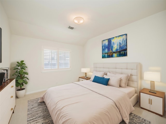 carpeted bedroom with vaulted ceiling