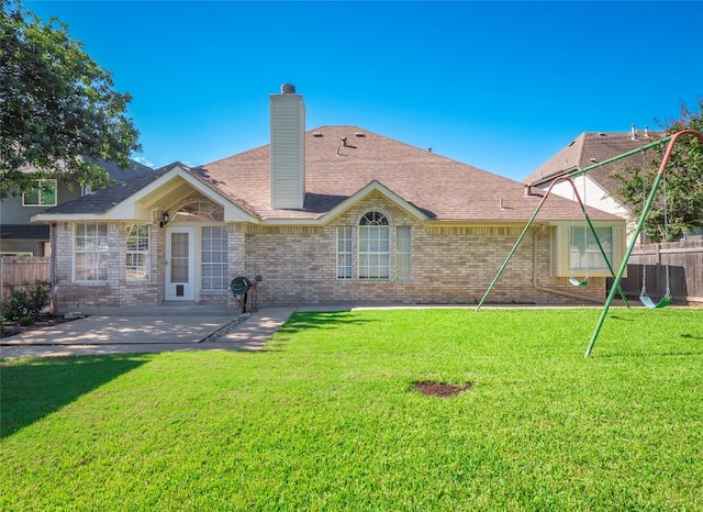 back of property featuring a lawn and a patio