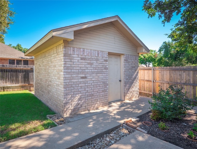 view of outbuilding featuring a yard