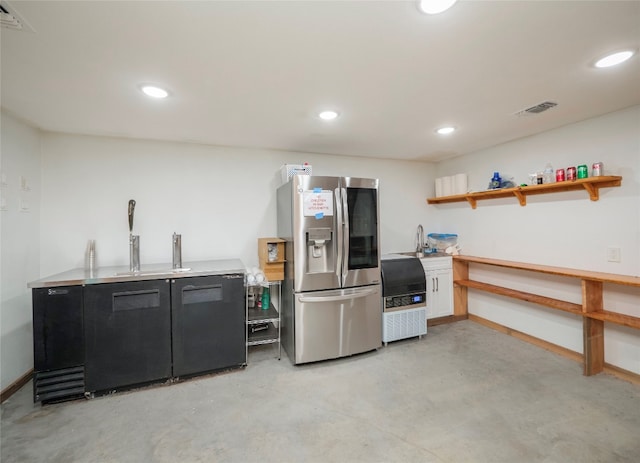 interior space with sink and stainless steel fridge with ice dispenser