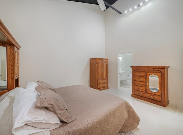 bedroom with a towering ceiling and ensuite bathroom