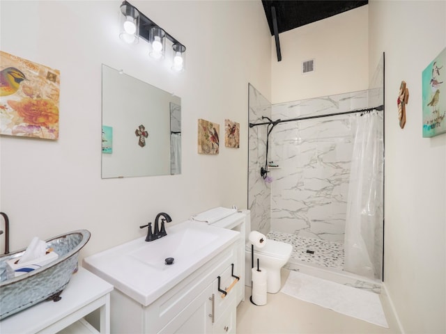 bathroom with toilet, vanity, curtained shower, and tile patterned flooring