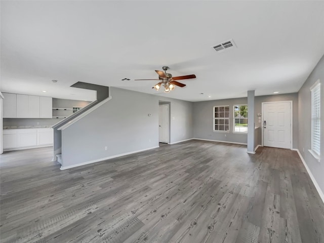 unfurnished living room featuring hardwood / wood-style floors and ceiling fan