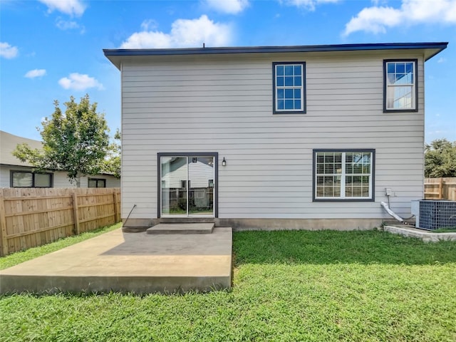 rear view of property with a yard, central AC unit, and a patio area