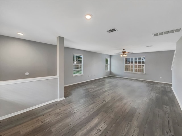 interior space with dark wood-type flooring and ceiling fan