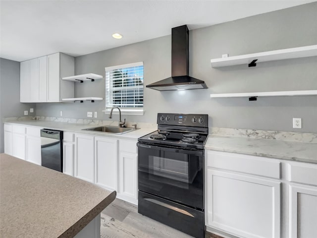 kitchen with white cabinetry, black electric range, sink, and wall chimney range hood