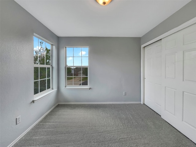 unfurnished bedroom with carpet and a closet