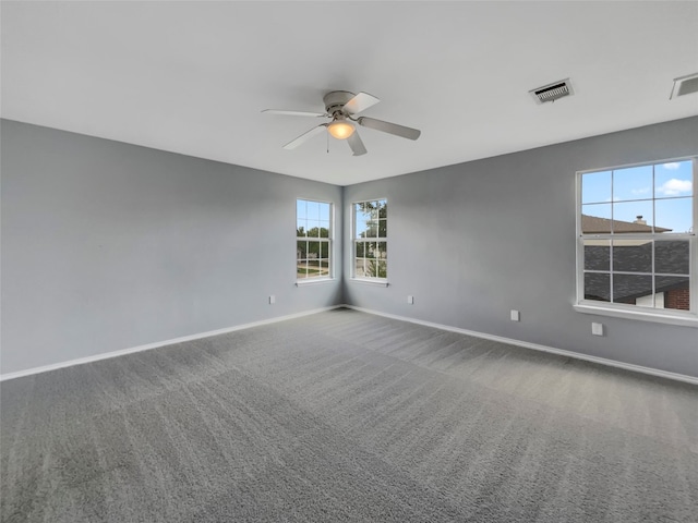 carpeted spare room with ceiling fan