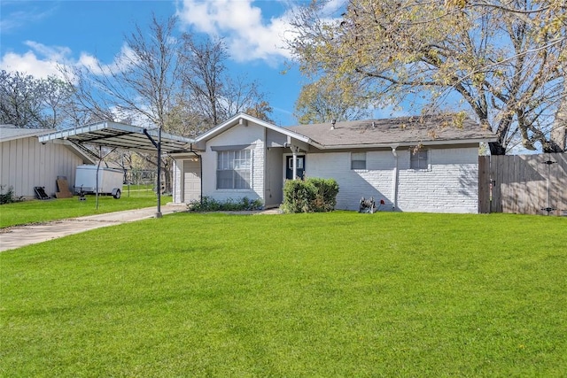 ranch-style home featuring a carport, a garage, and a front lawn