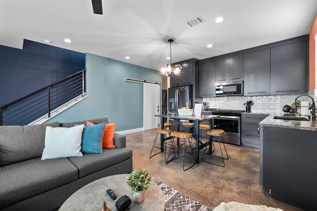 6217 Clovis St Unit B, Austin, TX 78741 - living room featuring a barn door, concrete floors, recessed lighting, and baseboards