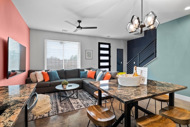 living room with ceiling fan and concrete flooring