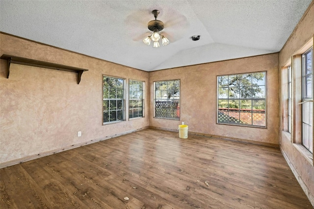 unfurnished sunroom with lofted ceiling and a ceiling fan