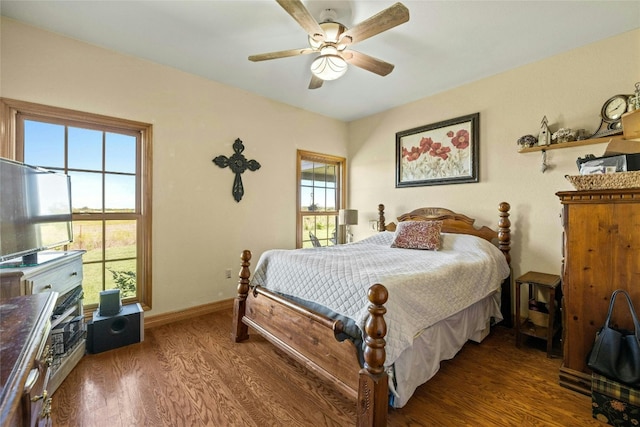 bedroom featuring a ceiling fan, wood finished floors, and baseboards