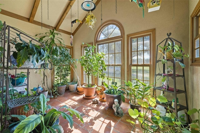 sunroom / solarium with vaulted ceiling with beams