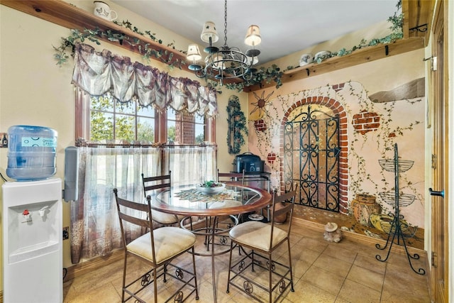 dining area with tile patterned floors and a notable chandelier