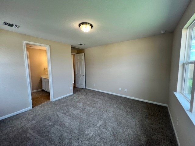 unfurnished bedroom with carpet and ensuite bathroom