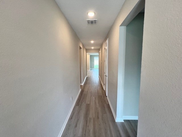 hall with dark hardwood / wood-style flooring