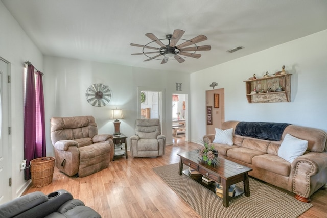 living room with light hardwood / wood-style floors and ceiling fan