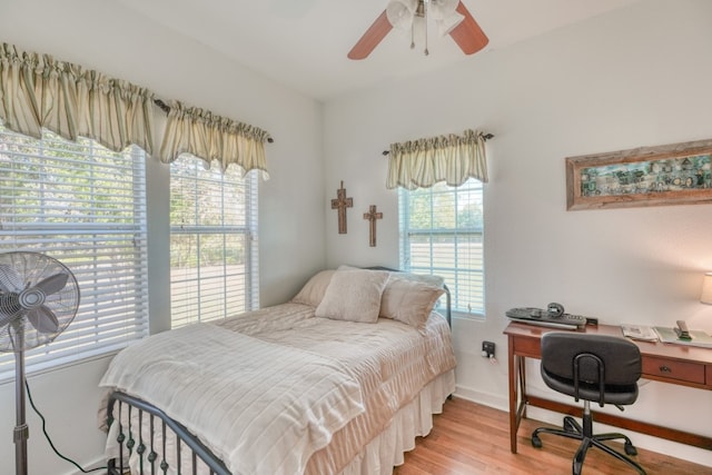 bedroom with light hardwood / wood-style flooring, multiple windows, and ceiling fan