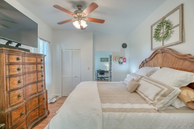 bedroom featuring ceiling fan, light hardwood / wood-style floors, and a closet