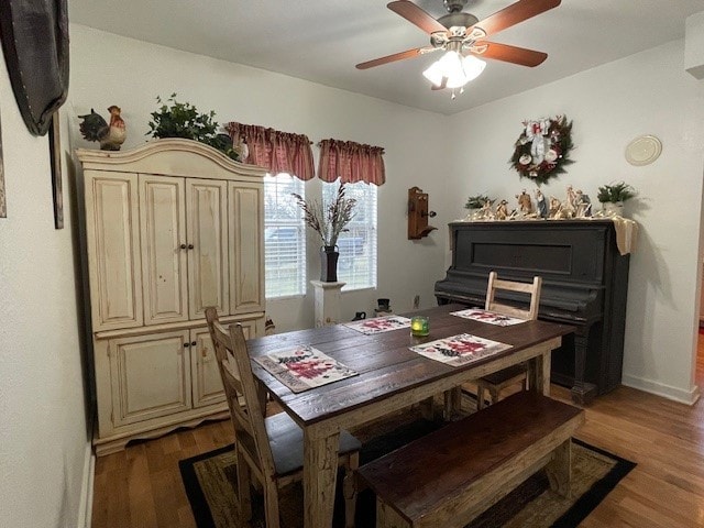 dining area with ceiling fan and wood-type flooring