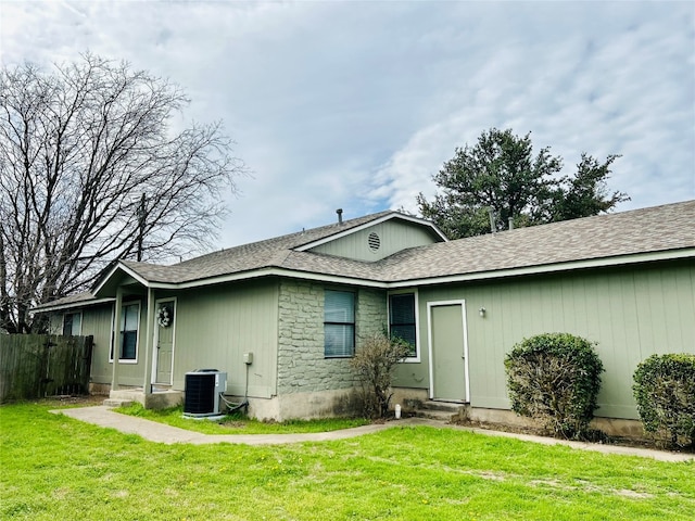 back of house featuring a lawn and central AC unit