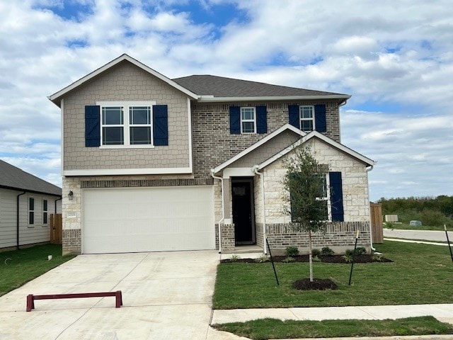 craftsman house featuring a garage and a front lawn