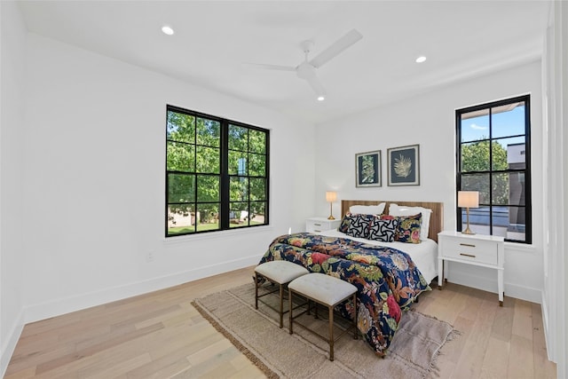 bedroom with light hardwood / wood-style floors and ceiling fan