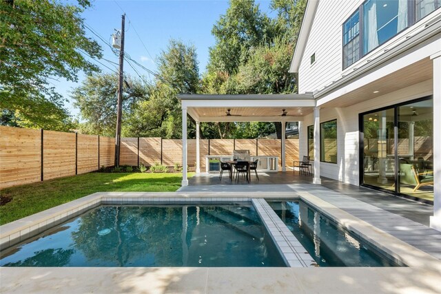 view of pool featuring ceiling fan and a patio area