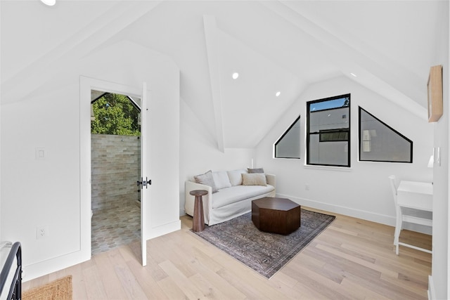 living area featuring light hardwood / wood-style flooring and lofted ceiling