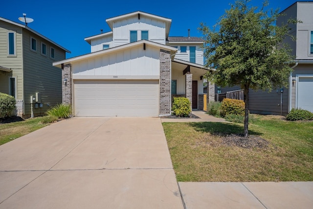 view of front of property with a front yard and a garage