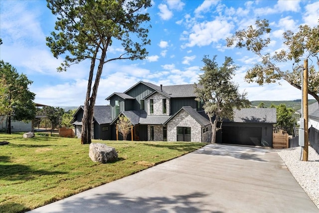 view of front of property with a front yard and a garage