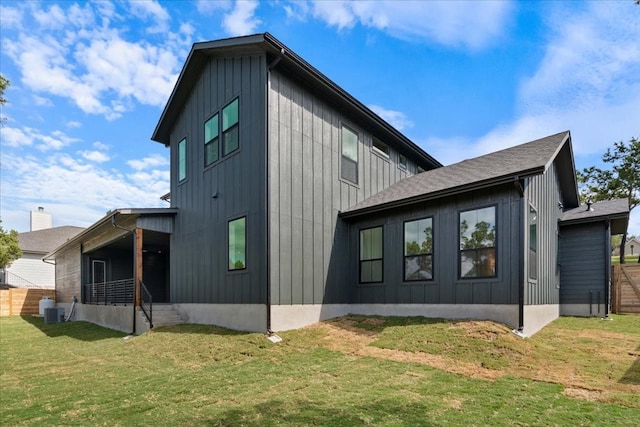 view of home's exterior with central AC and a lawn