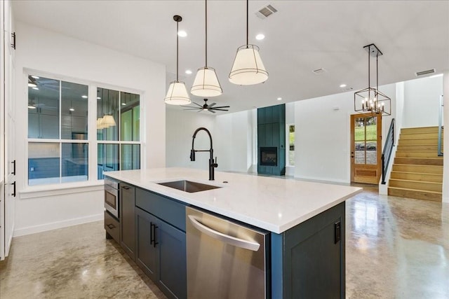 kitchen featuring visible vents, appliances with stainless steel finishes, a sink, ceiling fan with notable chandelier, and open floor plan