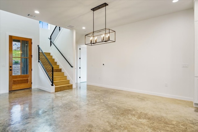 interior space featuring a notable chandelier and concrete floors