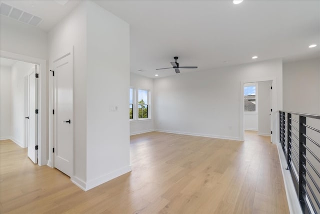 unfurnished living room featuring ceiling fan, light hardwood / wood-style flooring, and plenty of natural light