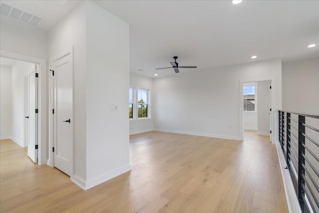unfurnished living room featuring light wood-style floors, a ceiling fan, baseboards, recessed lighting, and visible vents
