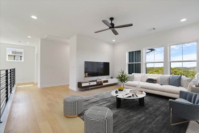 living room with ceiling fan and light wood-type flooring