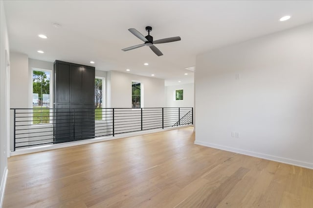 empty room with light hardwood / wood-style flooring and ceiling fan